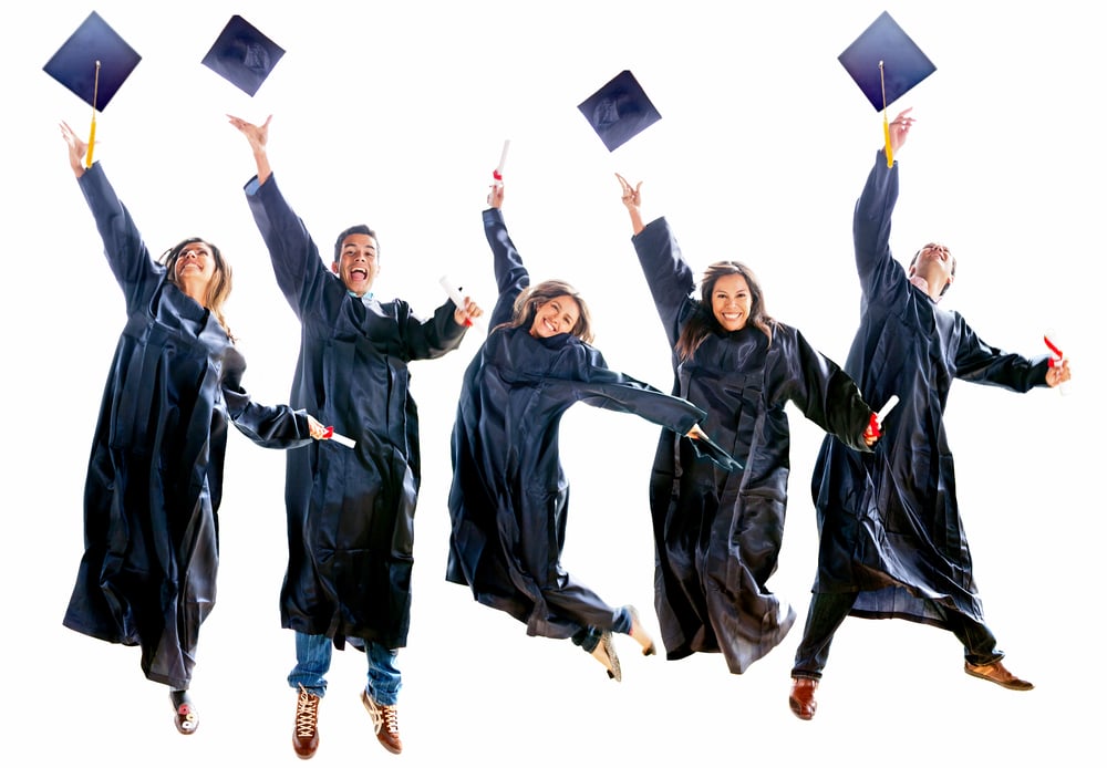 Group of excited people jumping in their gradutation throwing hats